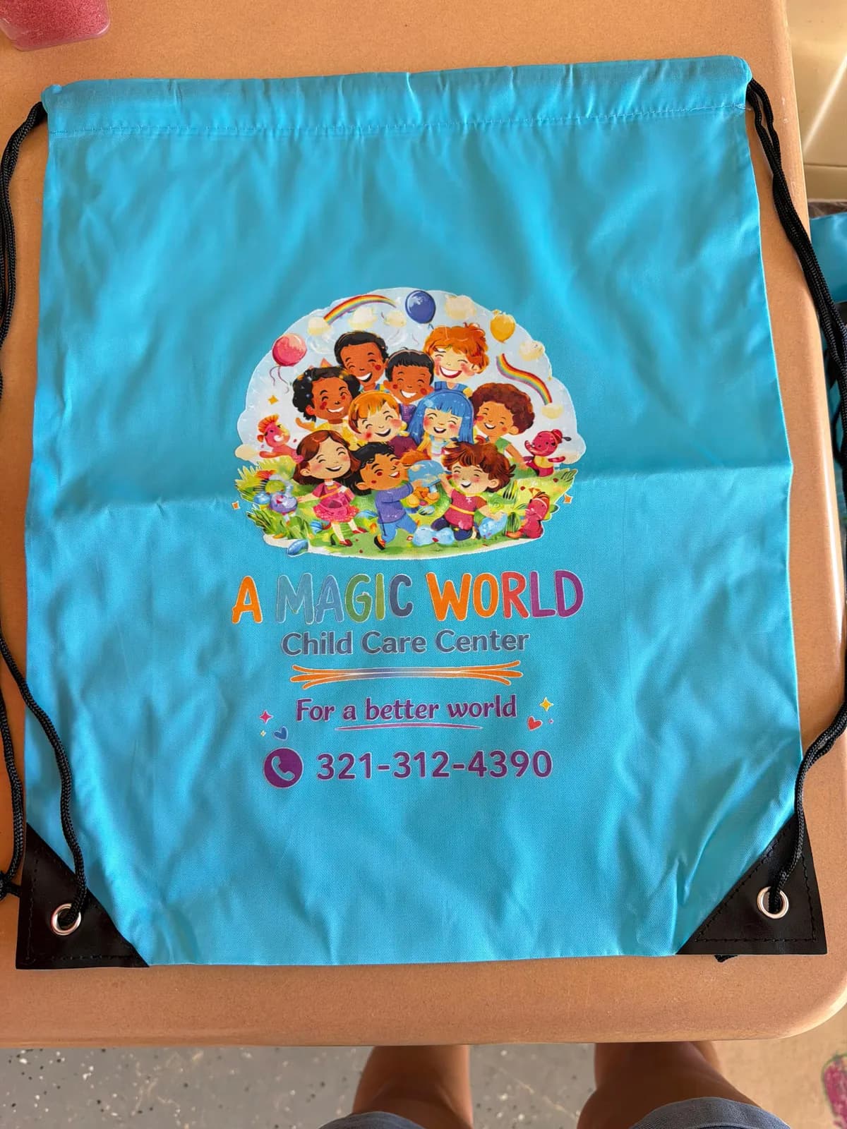 A Magic World Child Care Center branded drawstring bag