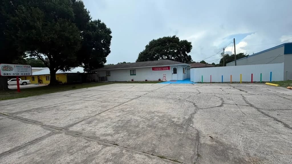 Front view of A Magic World Child Care Center building and private parking area in Palm Bay, FL