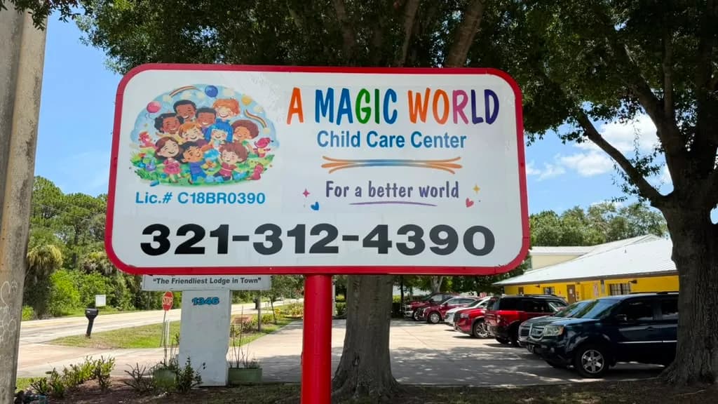 A Magic World Child Care Center road sign with DCF license number and phone number in Palm Bay, FL