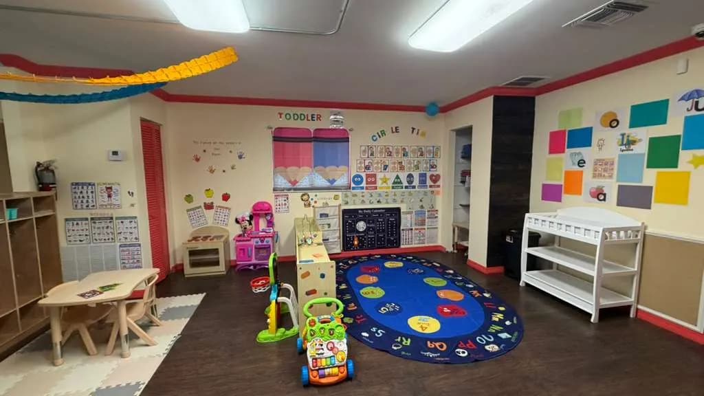 Toddler classroom set up for circle time with alphabet rug at A Magic World Child Care Center
