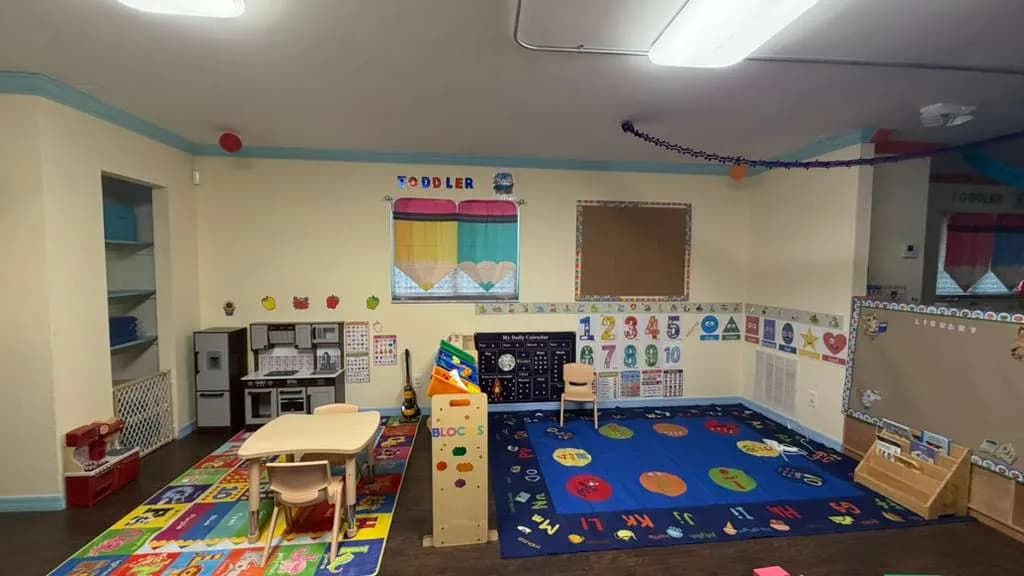 Toddler learning area with building blocks and number wall at A Magic World Child Care Center